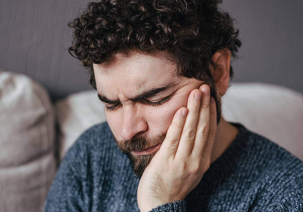 Man with jaw pain possibly needing Urgent Dental Care