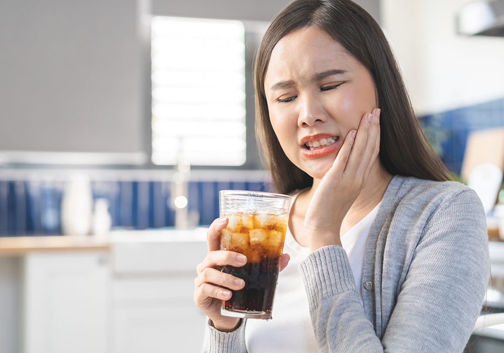 Woman with tooth sensitivity needing Emergency Dental Care