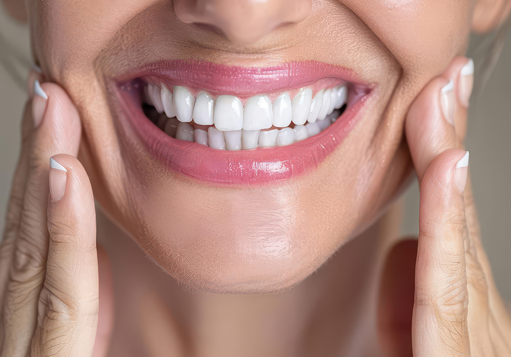 Affordable dentures and implants for missing teeth, showing bright white smile