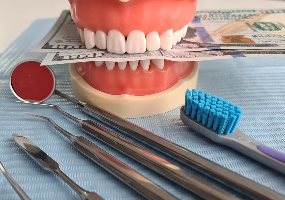 Dentures with cash showing cost of Emergency Dental Services