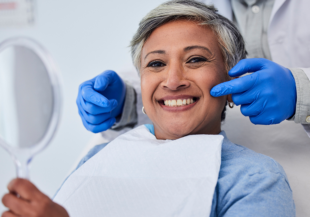 Smiling patient after dental treatment with dentist
