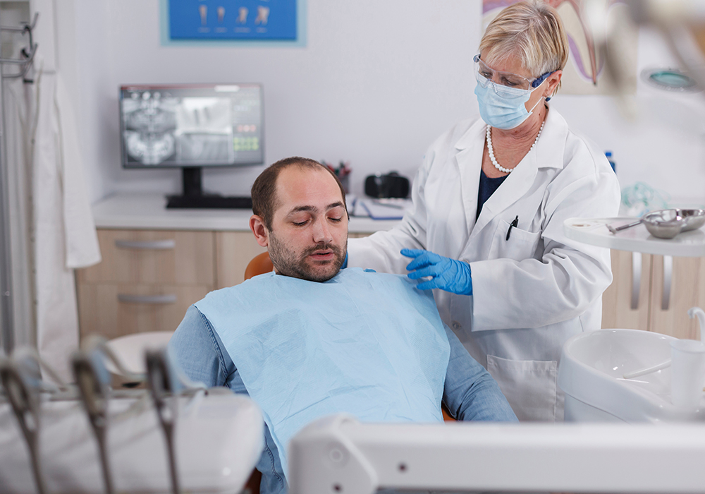 Patient receiving emergency dental treatment from dentist