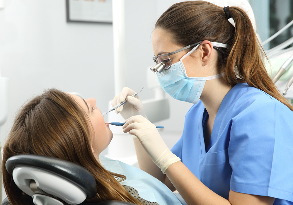 Dentist examining patient during checkup