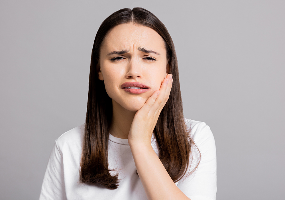 Woman with tooth pain possibly needing Dentist Emergency
